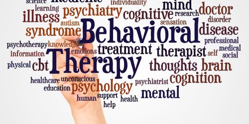 Behavioral Therapy word cloud and hand with marker concept behavioral word cloud